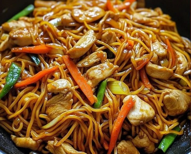 Bowl of Chicken Lo Mein with colorful vegetables and noodles