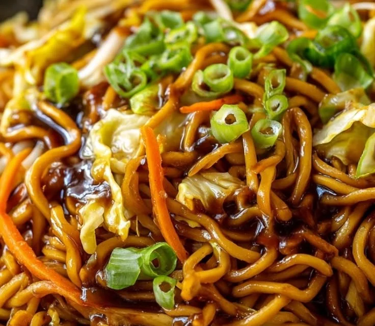 Delicious homemade Chow Mein served with colorful vegetables and shrimp.