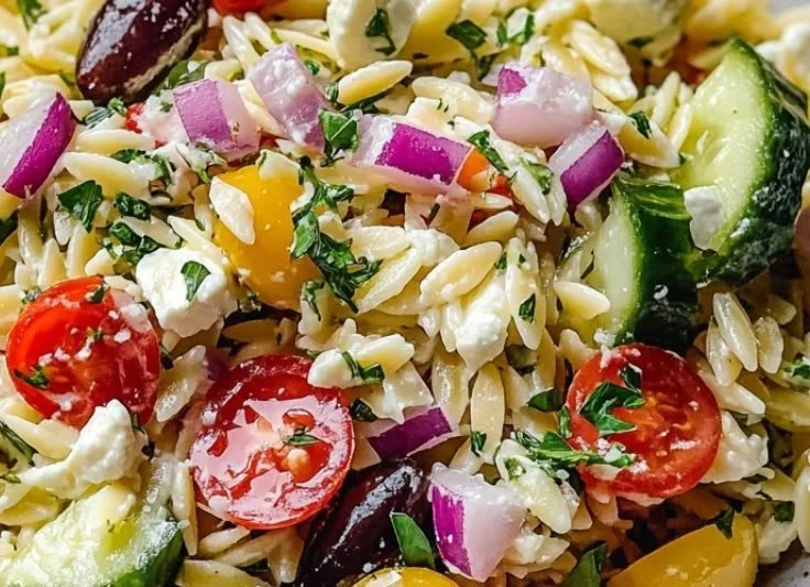 Bowl of Easy Greek Orzo Pasta Salad with fresh veggies and herbs
