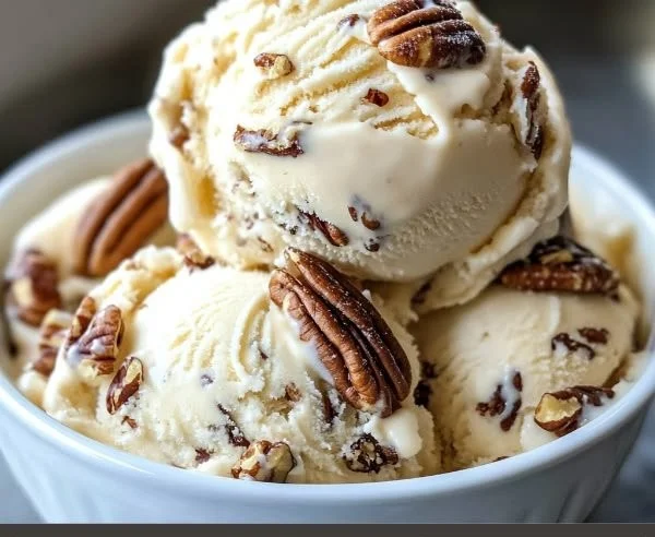 Homemade easy butter pecan ice cream in a bowl with pecans on top