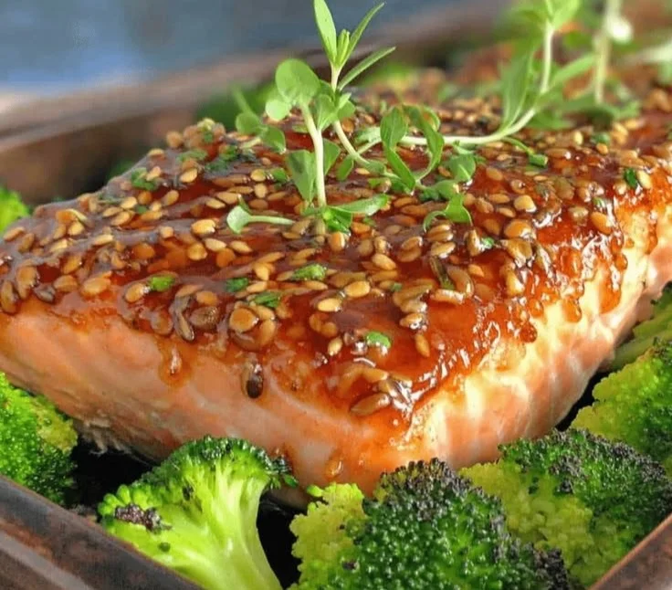 Sheet pan maple dijon salmon garnished with herbs, served for a weeknight dinner