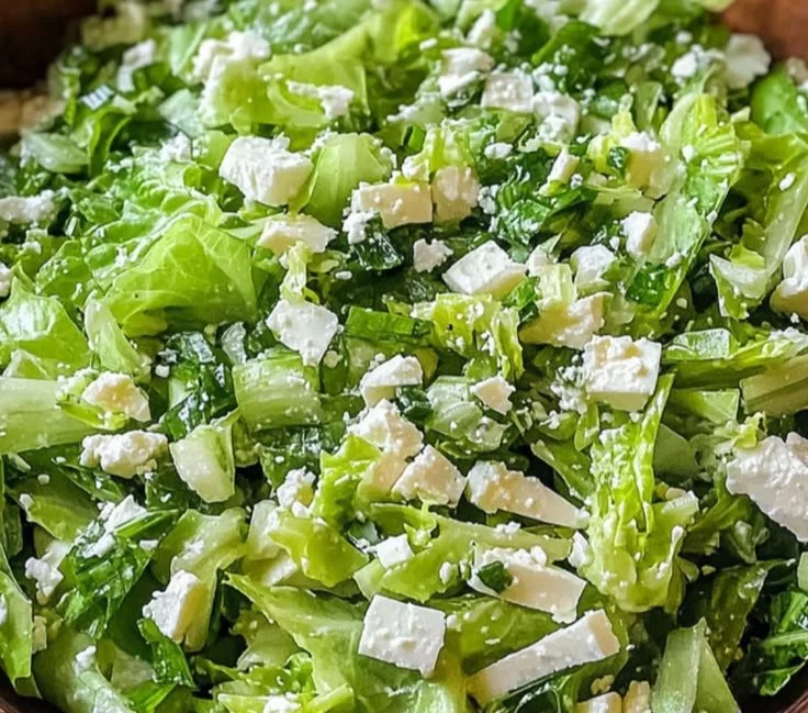 Fresh Greek Lettuce Salad with vegetables, olives, and feta cheese