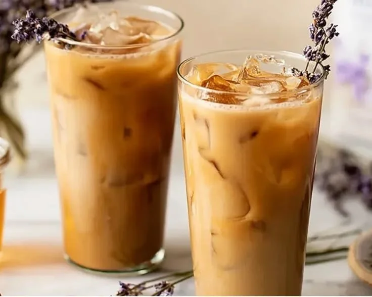 Iced Honey Lavender Latte served in a glass with lavender sprigs