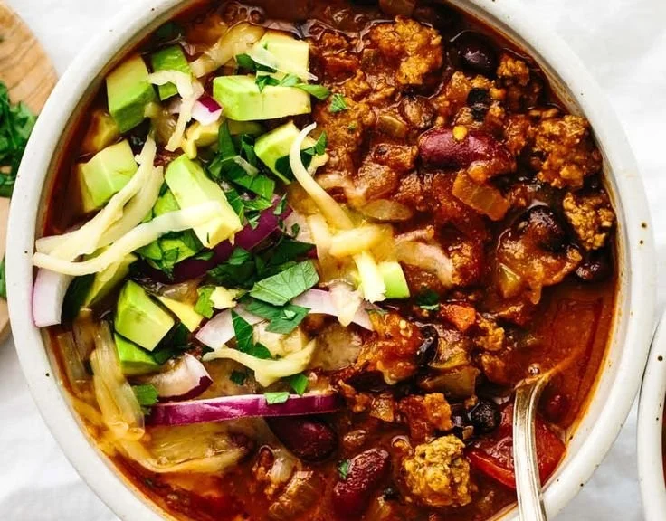 Delicious one-pot chili recipe bowl topped with cheese and cilantro
