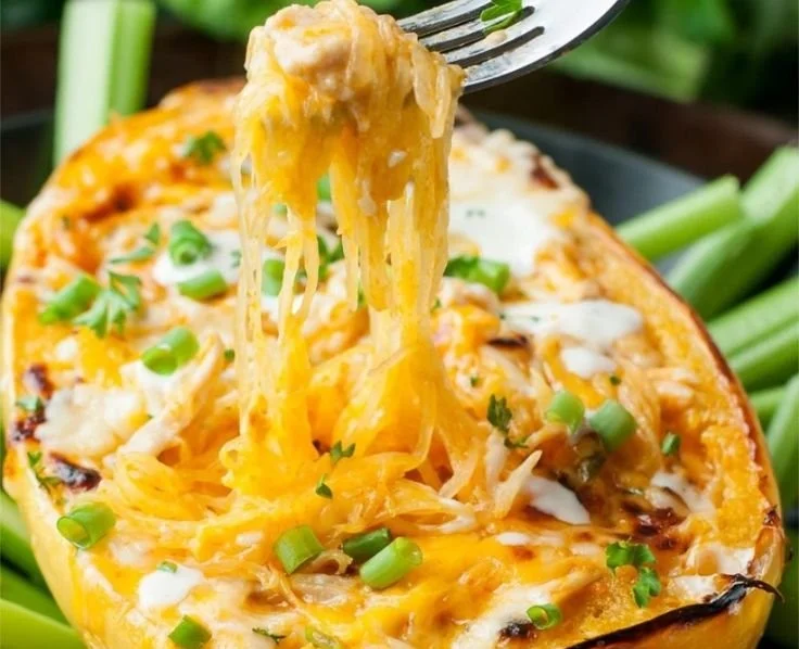 Buffalo Chicken Spaghetti Squash topped with sauce and herbs