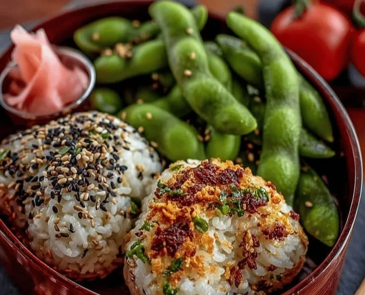 Delicious edamame rice balls served on a plate with fresh herbs.