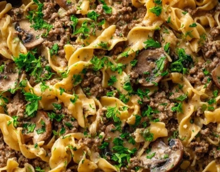 Ground Beef Stroganoff served with noodles and garnished with parsley
