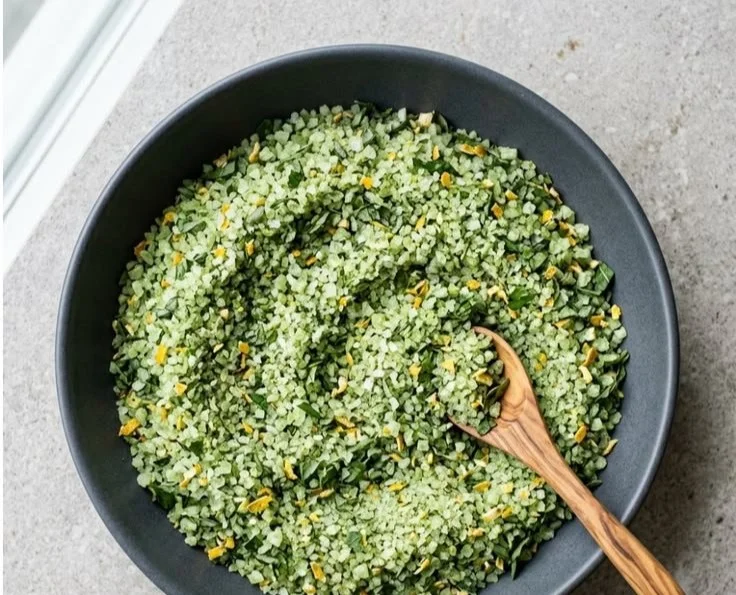 Homemade herbed salt recipe with fresh herbs and spices in a jar.