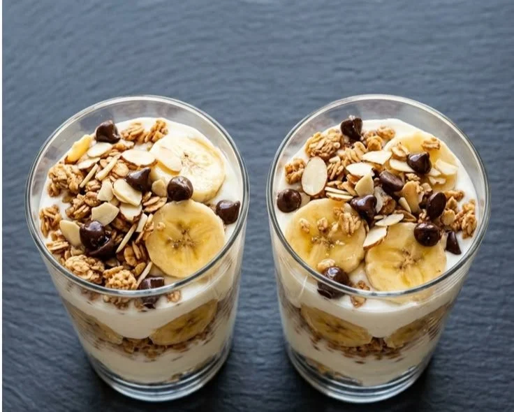 Protein Banana Pudding Yogurt Parfait with layers of pudding, yogurt, and banana slices.