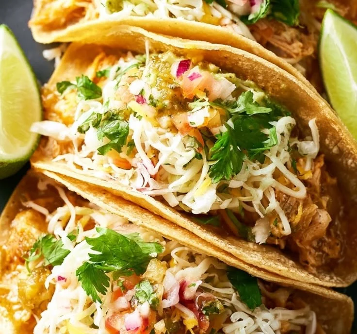 Delicious slow cooker salsa verde chicken tacos served with fresh toppings.