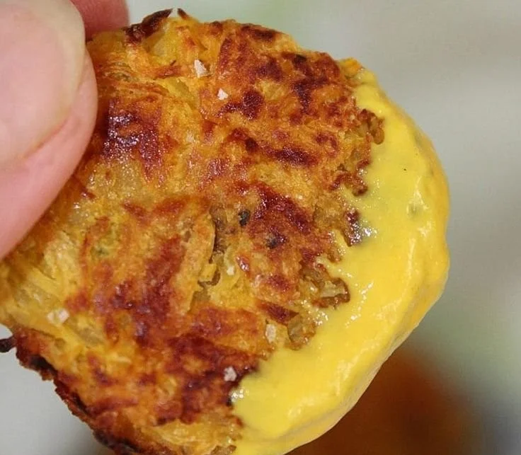 Baked spaghetti squash tots on a plate garnished with herbs