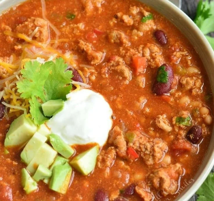 Bowl of savory Turkey Chili topped with fresh herbs and spices