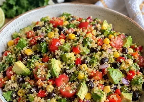 Mexican Quinoa Salad drizzled with honey lime vinaigrette in a colorful bowl